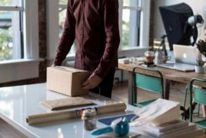 "E-commerce store manager packing cardboard parcel box for UK shipping
