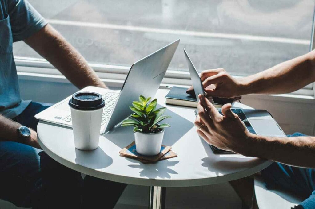 Two professionals sitting at a table discussing TikTok Shop management strategy