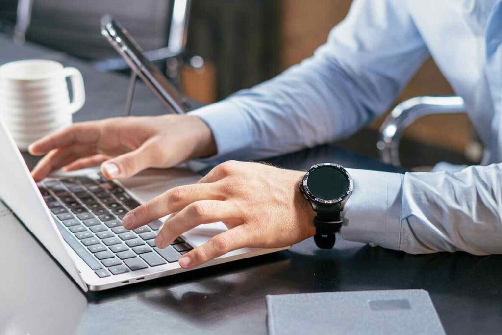 Small business owner managing admin tasks on a laptop before hiring a virtual assistant