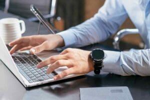 Small business owner managing admin tasks on a laptop before hiring a virtual assistant